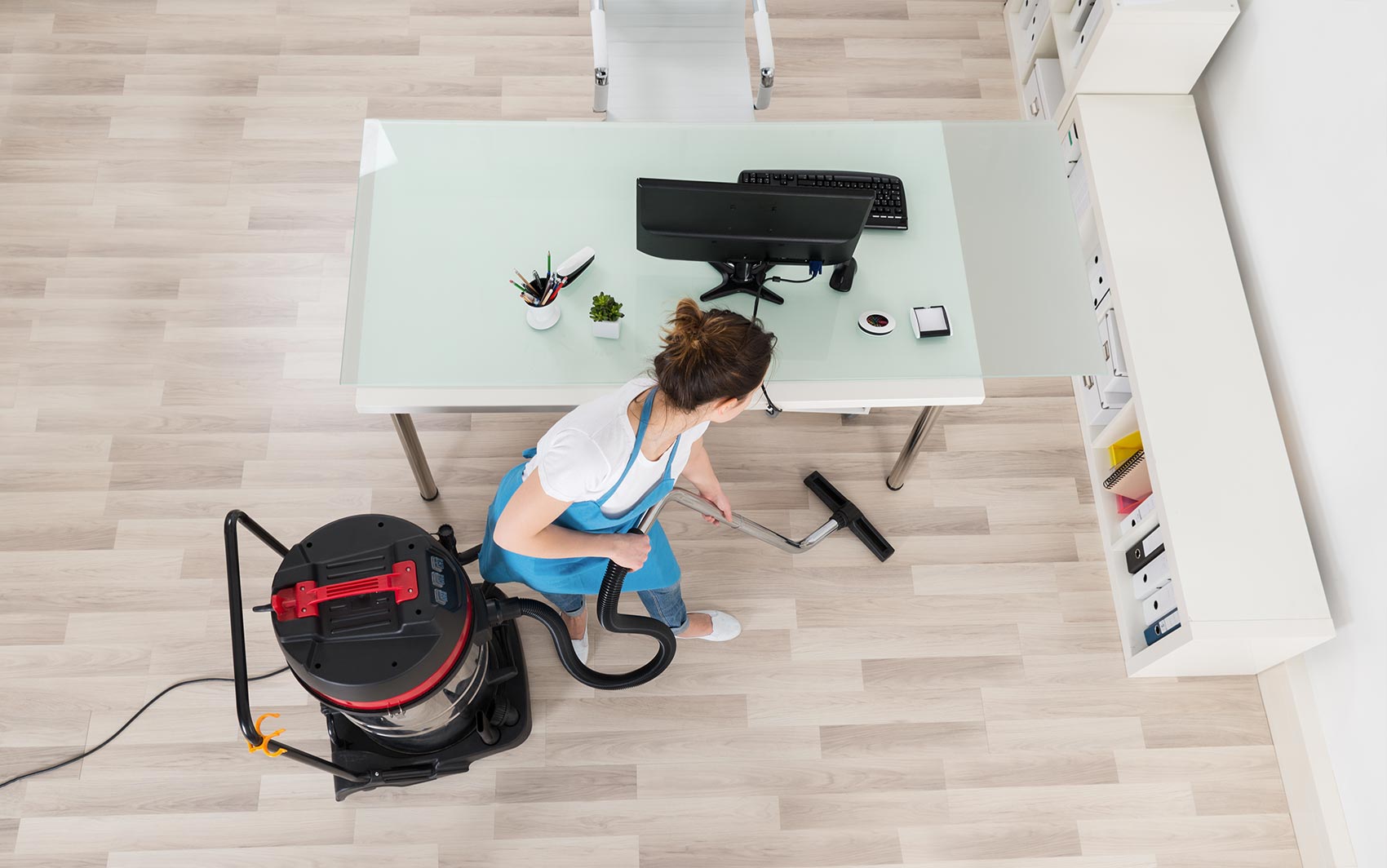 A professional cleaner, cleaning a large office space
