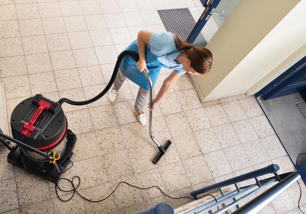 Professional cleaning in progress with cleaner using vacuum